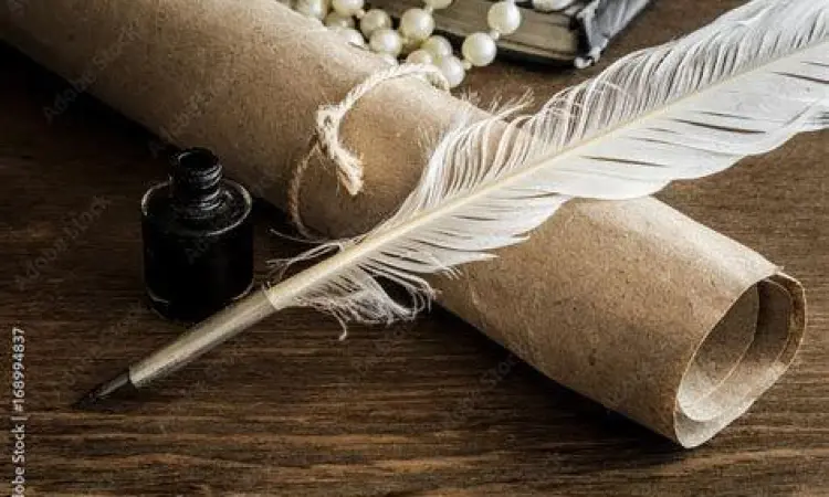 Pena bulu dan kertas tua untuk menulis puisi